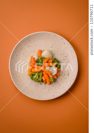 Delicious fresh vegetables broccoli, cauliflower, carrots steamed with salt and spices Delicious fresh vegetables broccoli, cauliflower, carrots steamed with salt and spices 110790711