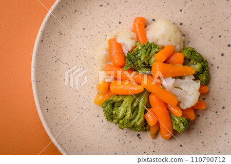 Delicious fresh vegetables broccoli, cauliflower, carrots steamed with salt and spices Delicious fresh vegetables broccoli, cauliflower, carrots steamed with salt and spices 110790712