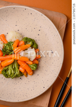 Delicious fresh vegetables broccoli, cauliflower, carrots steamed with salt and spices 110790716