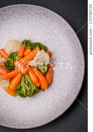 Delicious fresh vegetables broccoli, cauliflower, carrots steamed with salt and spices Delicious fresh vegetables broccoli, cauliflower, carrots steamed with salt and spices 110790726