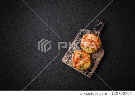 Delicious baked fish fillet with cheese, tomatoes, salt, spices and herbs 110790764