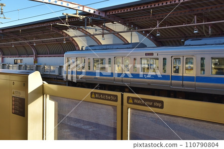 Odakyu Line at Umegaoka Station platform on a sunny day in Tokyo 110790804