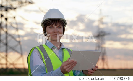 Happy electrician setups equipment via tablet at power distribution substation Happy electrician setups equipment via tablet at power distribution substation 110790886