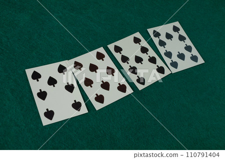 Old west era playing card on gambling table. 7, 8, 9, 10 of spades. 110791404