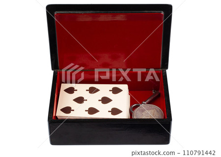 vintage old black and red casket with vintage playing cards and silver dollar coins 110791442