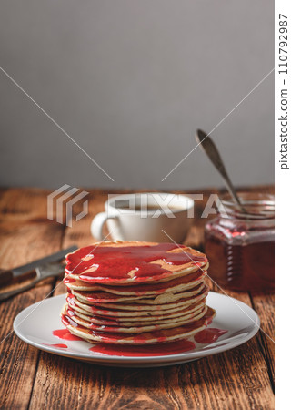 Stack of pancakes with berry jam 110792987