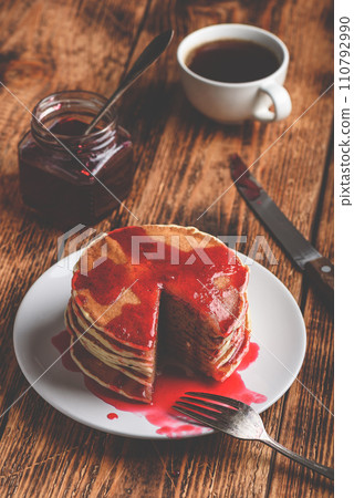 Stack of american pancakes with red berry jam 110792990