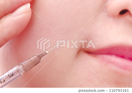 A woman receiving an injection in her mouth A woman receiving an injection in her mouth 110793161