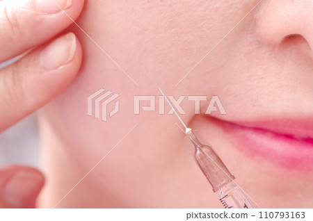 A woman receiving an injection in her mouth A woman receiving an injection in her mouth 110793163