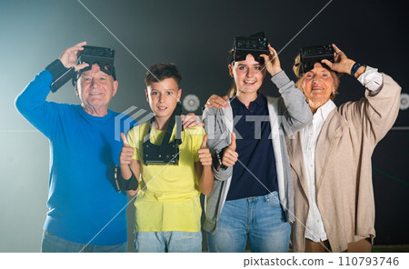 Group photo of happy family in VR headsets 110793746