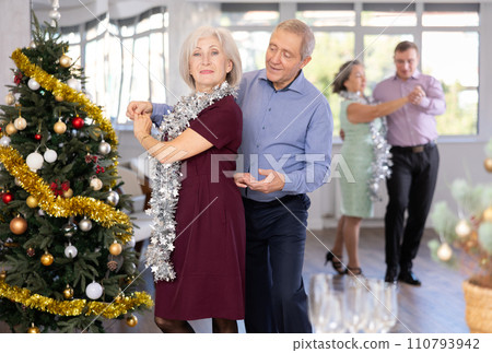 Happy adult man and woman performing ballroom dance in dancing room during celebration Christmas and New Year 110793942
