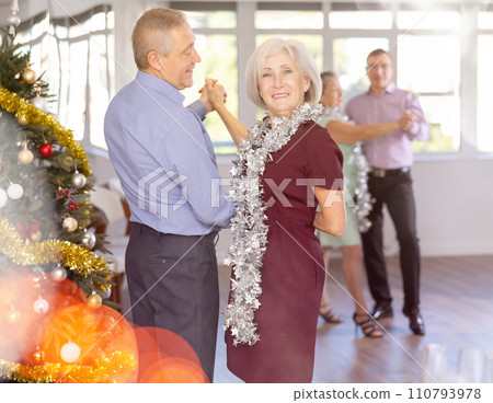 In studio decorated for New Year, elderly man and woman perky dance pair discofox. In studio decorated for New Year, elderly man and woman perky dance pair discofox. 110793978