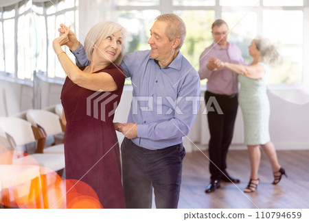 Senior man and elderly woman are dancing classic version of waltz in couple 110794659