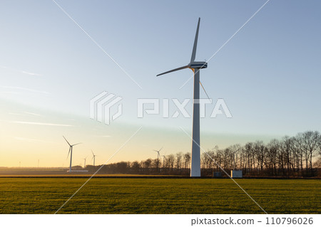 Aerial view of powerful Wind turbine farm for energy production on beautiful cloudy sky at highland. Wind power turbines generating clean renewable energy for sustainable development. 4k footage. 110796026