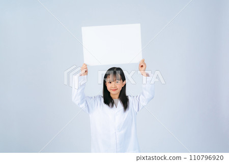 girl showing a message board girl showing a message board 110796920