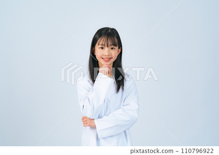 A girl wearing a white coat thinking A girl wearing a white coat thinking 110796922