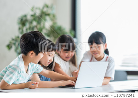 Elementary school students working together on computers. 110797241