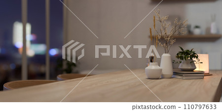 A copy space on a wooden dining table with decor in a cosy Scandinavian home dining room. A copy space on a wooden dining table with decor in a cosy Scandinavian home dining room. 110797633