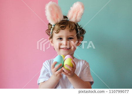 young boy kid holding colorful pastel easter eggs with generative ai 110799077