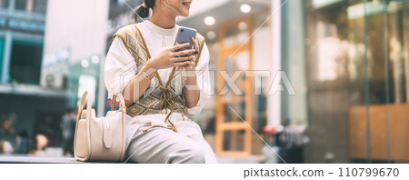 Casual business asian woman using smartphone city lifestyles with modern technology 110799670