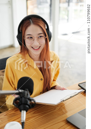 Female podcaster making audio podcast from her home studio Female podcaster making audio podcast from her home studio 110799682