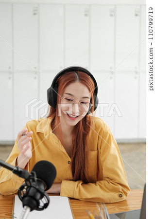 Female podcaster making audio podcast from her home studio 110799719