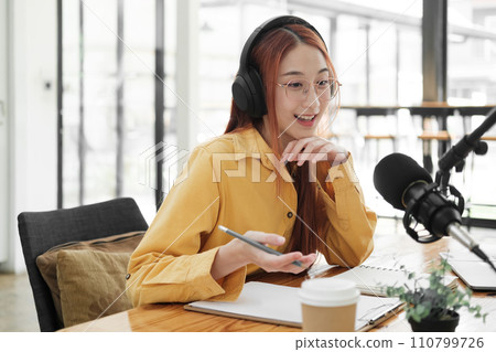 Live Podcast Session with Smiling Female Host. Live Podcast Session with Smiling Female Host. 110799726