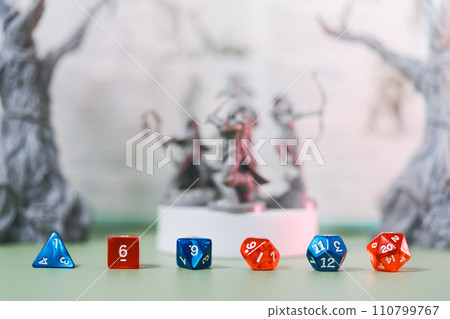 Blue and red dice place on adventure story TTRPG book role playing tabletop game and board game Blue and red dice place on adventure story TTRPG book role playing tabletop game and board game 110799767