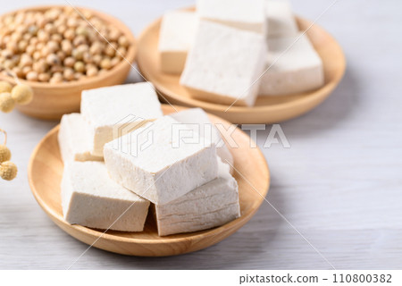 Fresh tofu in wooden bowl, Vegan food ingredient in Asian cuisine, Plant based diet Fresh tofu in wooden bowl, Vegan food ingredient in Asian cuisine, Plant based diet 110800382