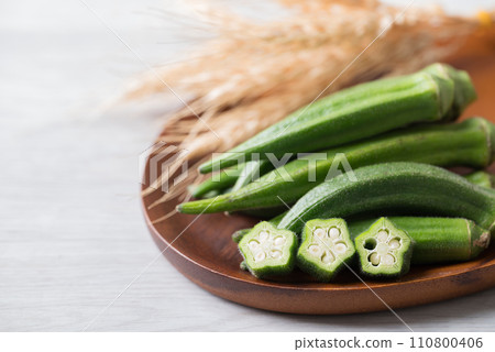 Green okra on wooden plate prepare for cooking, Organic vegetables Green okra on wooden plate prepare for cooking, Organic vegetables 110800406
