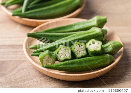 Green okra in wooden bowl prepare for cooking, Organic vegetables Green okra in wooden bowl prepare for cooking, Organic vegetables 110800407
