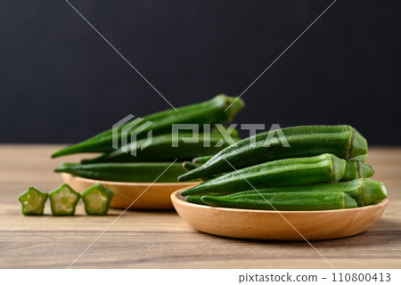 Green okra in wooden bowl prepare for cooking, Organic vegetables Green okra in wooden bowl prepare for cooking, Organic vegetables 110800413