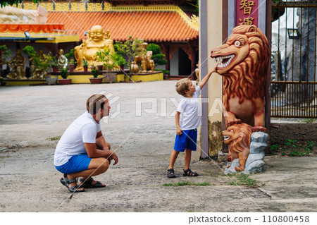 Father and son tourists walking in Vietnam Buddhist Temple, happy childhood, exploring world 110800458
