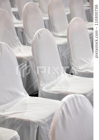 Rows of white chairs 110800786