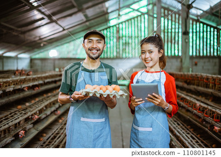Male and female entrepreneur carrying egg tray and holding tablet Male and female entrepreneur carrying egg tray and holding tablet 110801145