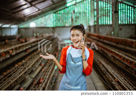 Asian woman entrepreneur chats on phone call with hand presenting 110801353