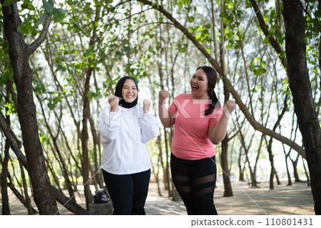 asian women sportswear standing with fist pump gesture asian women sportswear standing with fist pump gesture 110801431