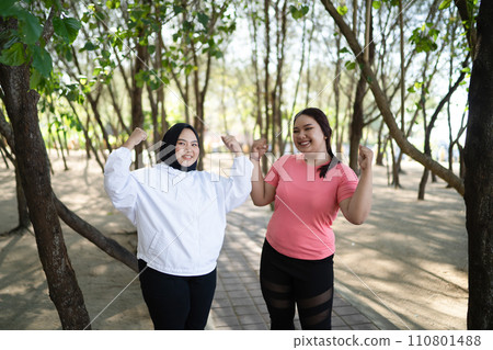 asian women standing with strong arm gesture 110801488