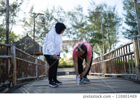 asian women taking rest after jogging 110801489