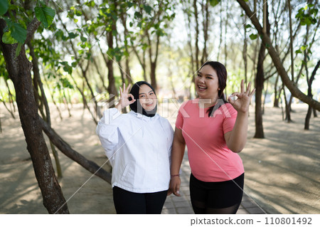 asian women standing with ok gesture asian women standing with ok gesture 110801492