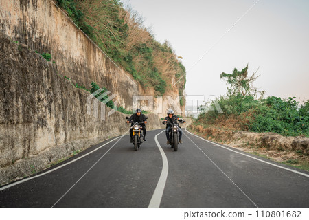 indonesian men enjoying riding motorcycle outdoors 110801682