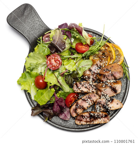 pieces of Organic grilled Tuna Steak on black ceramic serving dish with salad isolated pieces of Organic grilled Tuna Steak on black ceramic serving dish with salad isolated 110801761