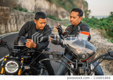 asian male riders sitting motorbike conversating 110801868