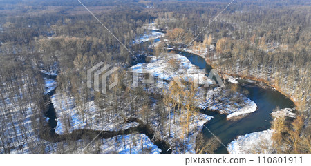 River winter floodplain delta snow meander drone aerial inland video shot in sandy sand alluvium freezing cold frost, benches forest and lowlands wetland swamp, quadcopter view flying fly flight show 110801911