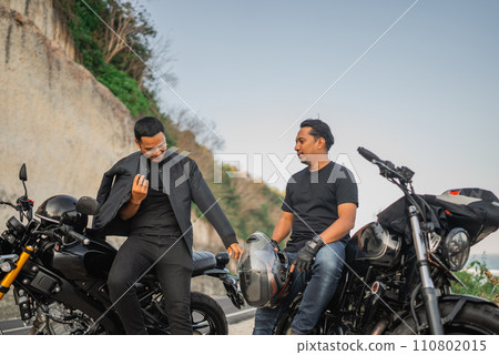 asian men sitting on motorbike outdoors asian men sitting on motorbike outdoors 110802015