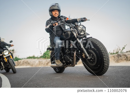 asian motorcyclist on jacket and helmet traveling asian motorcyclist on jacket and helmet traveling 110802076