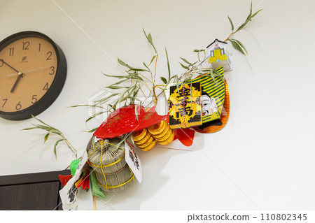 Lucky bamboo grass and clock hanging on the wall 110802345