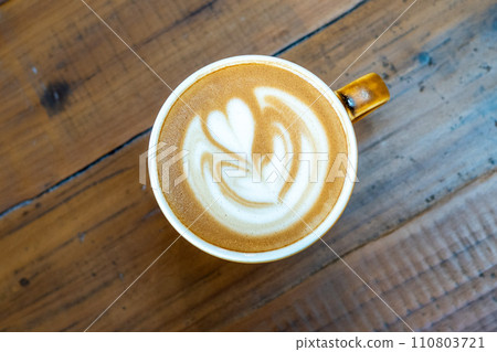 Latte art drawn on a latte on a wooden table 110803721