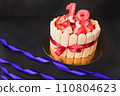 18 birthday party. strawberry tiramisu cake on black background with ribbon. Focus on strawberries. 110804623