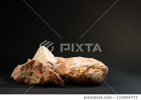 Pieces of granite stone on black background studio shot Pieces of granite stone on black background studio shot 110804755
